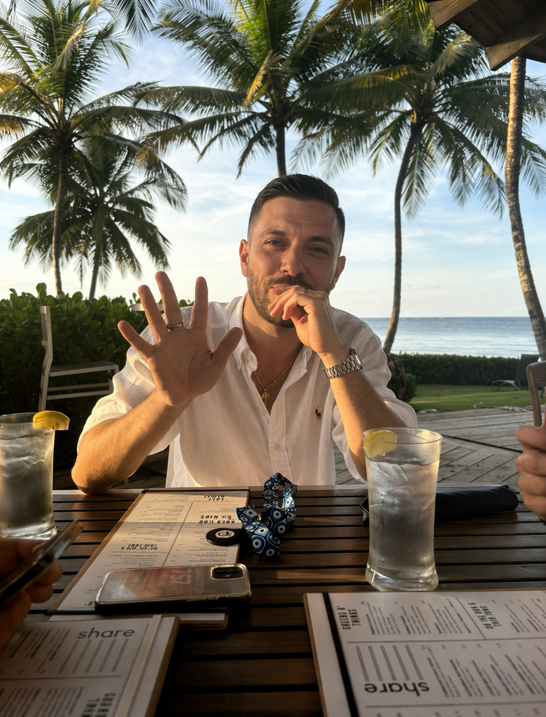 Vinny Walker working from a beach table with a translucent brand-colored overlay